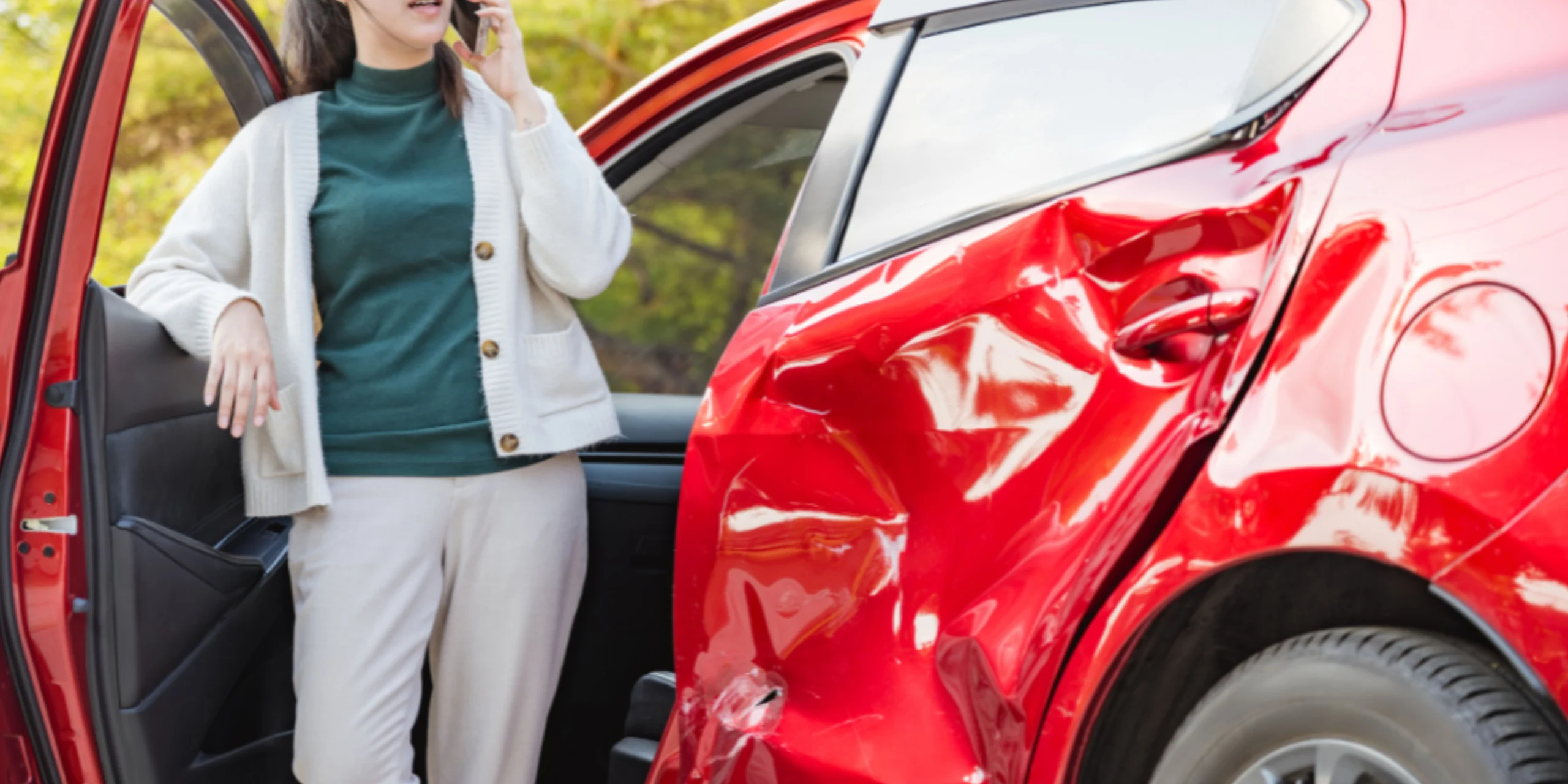 Image of a female driving making a call with a car from an accident